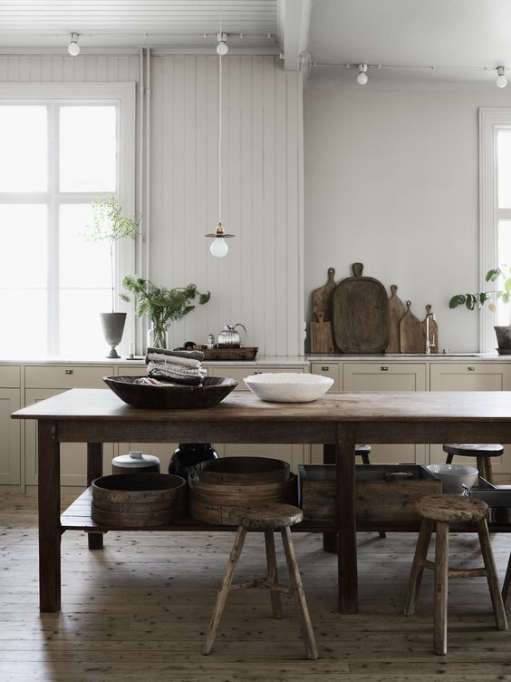 kitchen-with-big-old-wooden-table-and-raw-wooden-stools